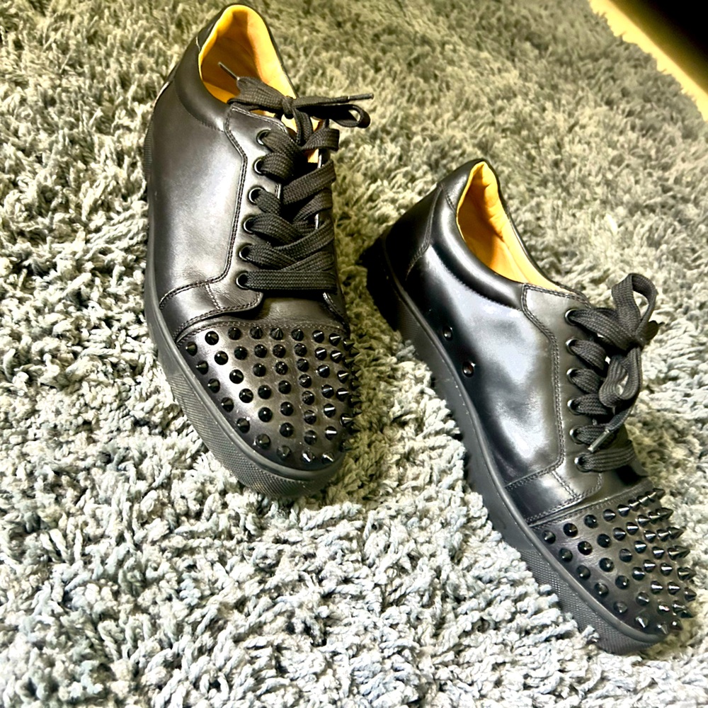 Black low cut Christian Louboutin spiked sneakers. Size 8 in Men and 10 in Women